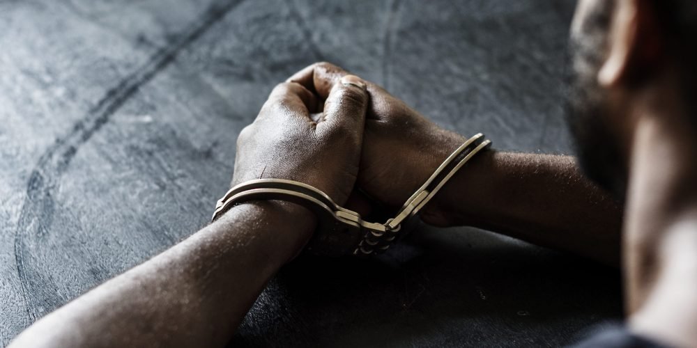 Arrested man with handcuffs on wrists